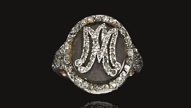 A small oval shape ring holds a lock of Marie Antoinette’s hair. Her initials are set in small rose cut diamonds on the top of the oval. A small oval shape ring holds a lock of Marie Antoinette’s hair. Her initials are set in small rose cut diamonds on the top of the oval.
